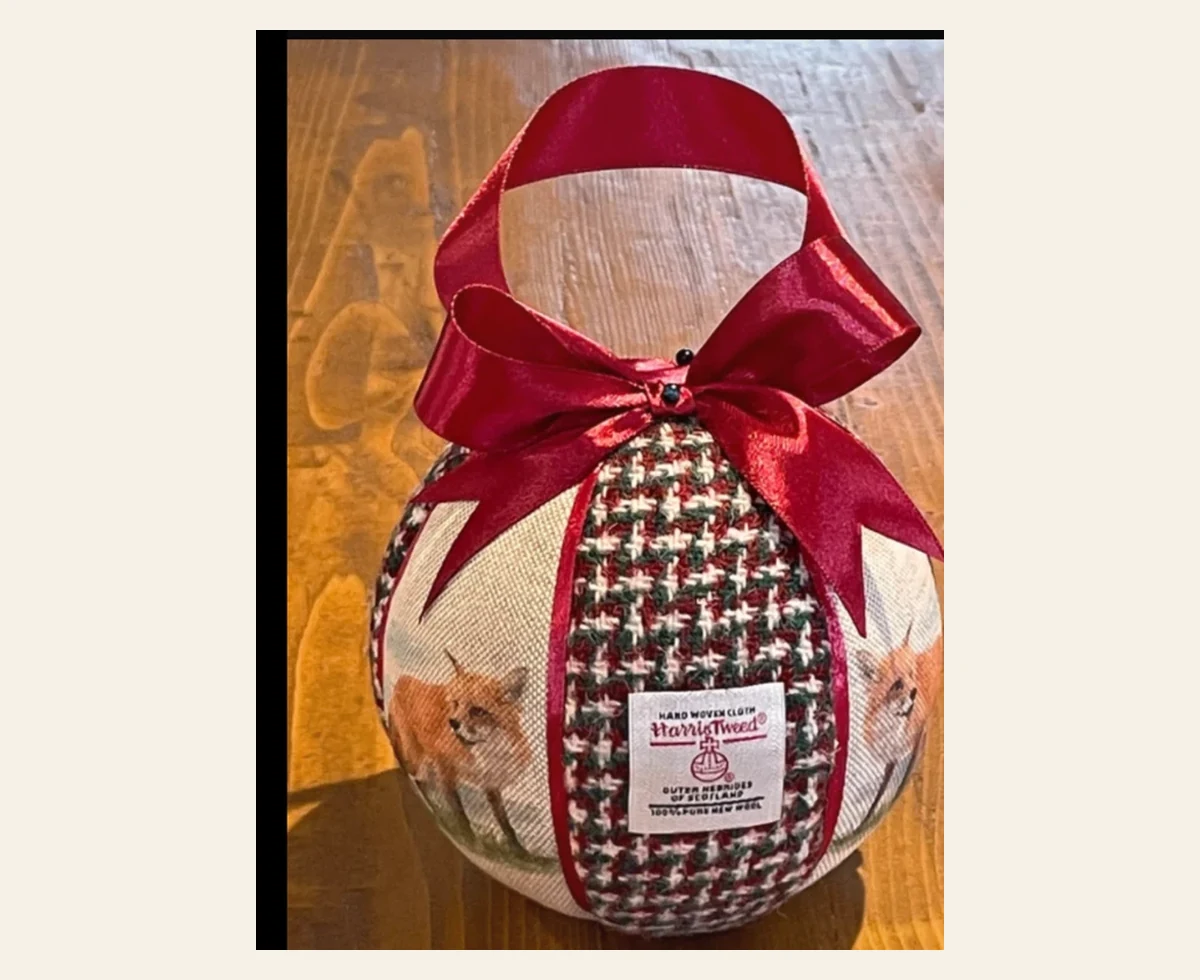 Handmade Harris Tweed Christmas bauble with burgundy bow and hanging ribbon